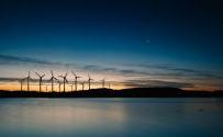 Wind turbines over water at night